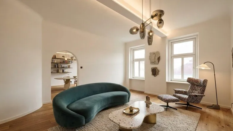 Moderner Wohnbereich mit geschwungenem Sofa, stilvoller Beleuchtung und Blick durch einen eleganten Bogen in einen weiteren Raum.