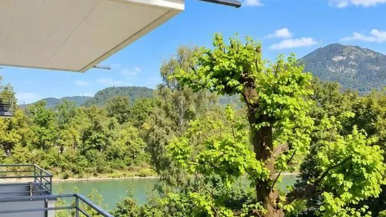 Geräumiger Balkon mit Geländer und malerischem Blick auf den See und die umliegende Natur.