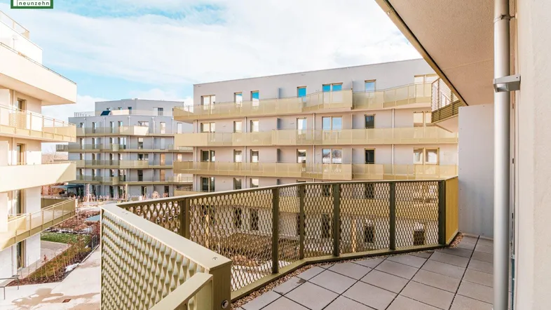 Großer Balkon mit moderner Metallbrüstung und Blick auf die umliegenden Gebäude.