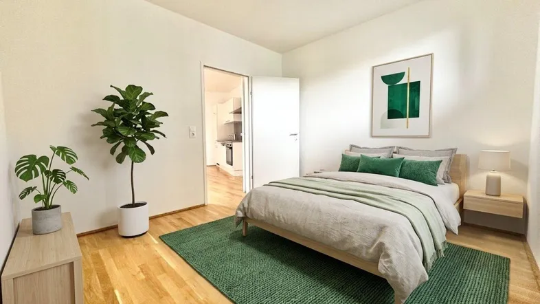 Helles Schlafzimmer mit Holzboden, grünem Teppich und Zugang zu einem weiteren Raum.
