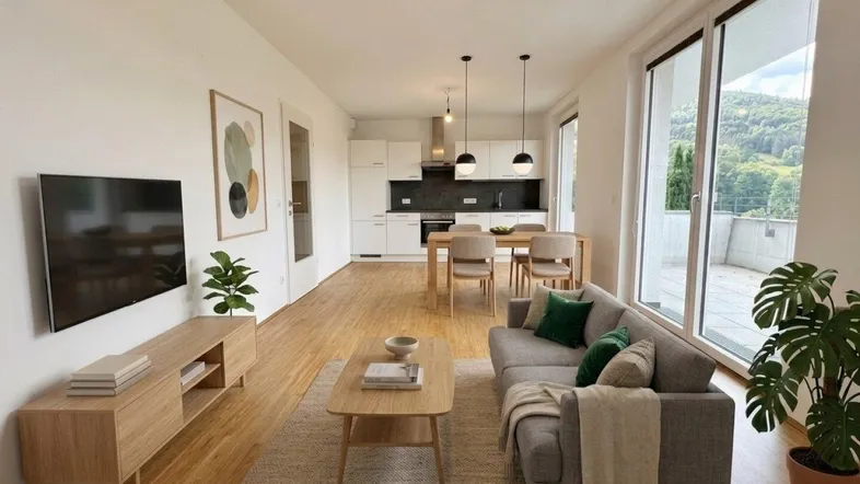 Modernes, offenes Wohnzimmer mit integrierter Küche, Holzboden und Zugang zu einer Terrasse mit Bergblick.
