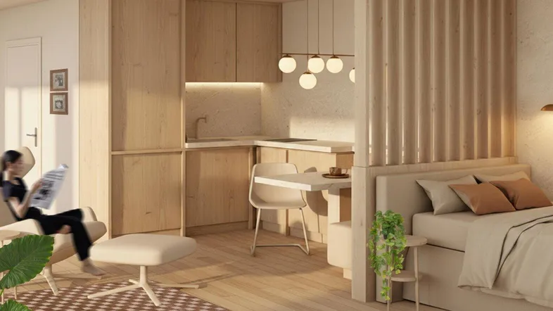 Modernes Studio-Apartment mit integrierter Küche, Schlafbereich und gemütlicher Sitzecke.