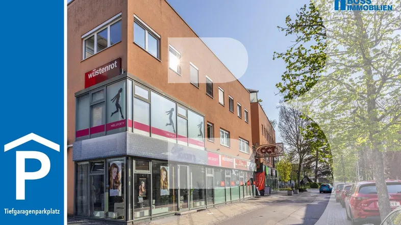 Gebäude mit Geschäftsflächen im Erdgeschoss und Wohnungen in den oberen Etagen, an einer belebten Straße gelegen.