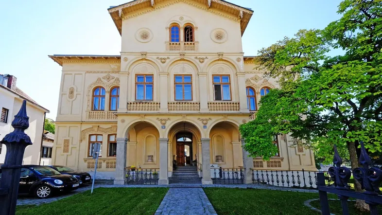 Prächtige historische Villa mit aufwendiger Fassadengestaltung und gepflegtem Vorgarten.