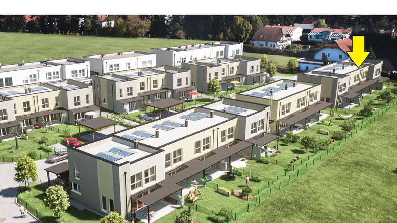 Luftaufnahme einer modernen Reihenhaussiedlung mit Gärten und Solaranlagen auf den Dächern.
