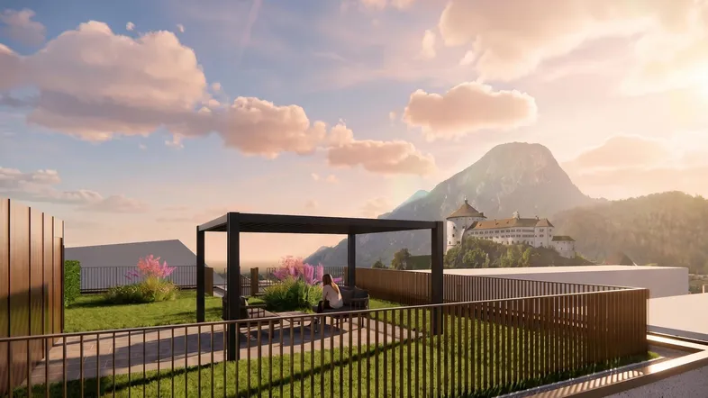 Grüne Dachterrasse mit Pergola, Sitzbereich und malerischem Bergblick auf eine Burg.