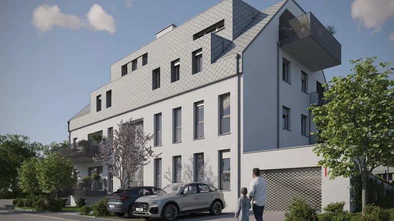 Ansicht der modernen Wohnanlage mit Parkplätzen und Garagenzufahrt.