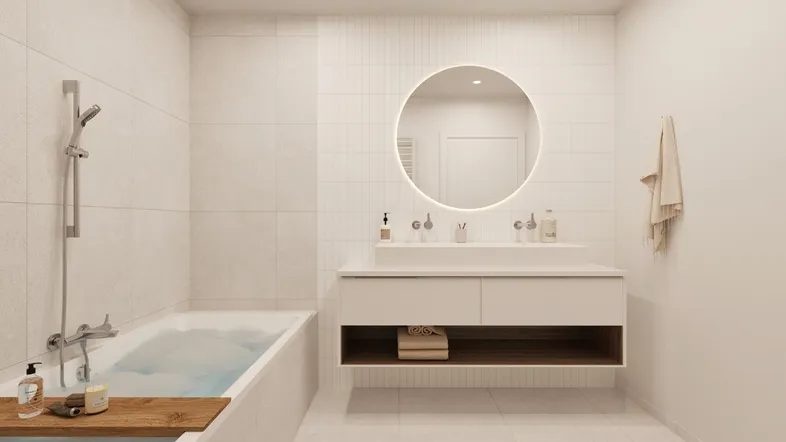 Helles Badezimmer mit moderner Badewanne, Waschtisch und beleuchtetem Spiegel.