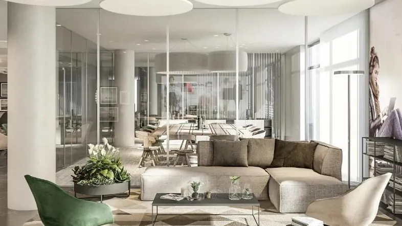 Moderner Loungebereich mit bequemen Sofas, Glastrennwänden und dekorativen Deckenplatten, ideal für Entspannung.