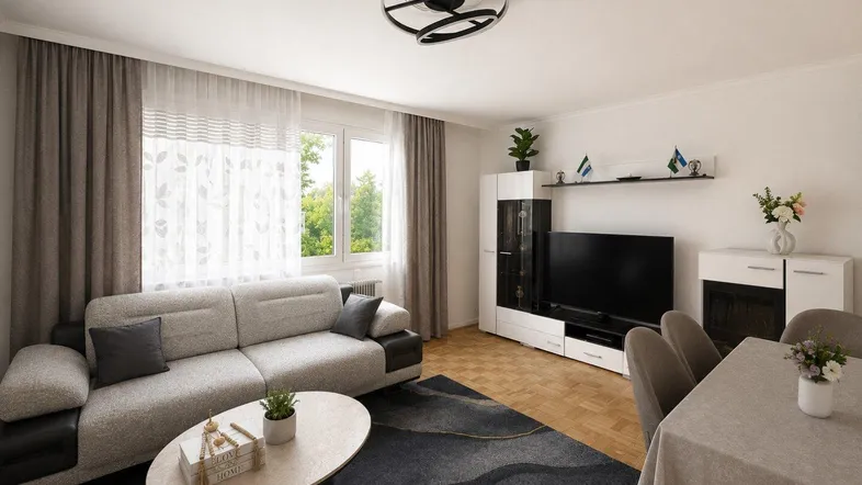 Heller Wohn- und Essbereich mit modernem Sofa, Esstisch und Blick ins Grüne.
