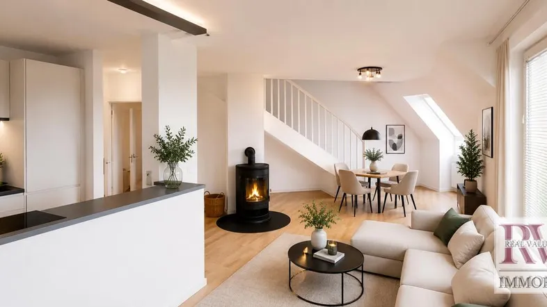Helles, offenes Wohn-Esszimmer mit Kaminofen, Holzboden und integrierter Küchenzeile unter Dachschräge.