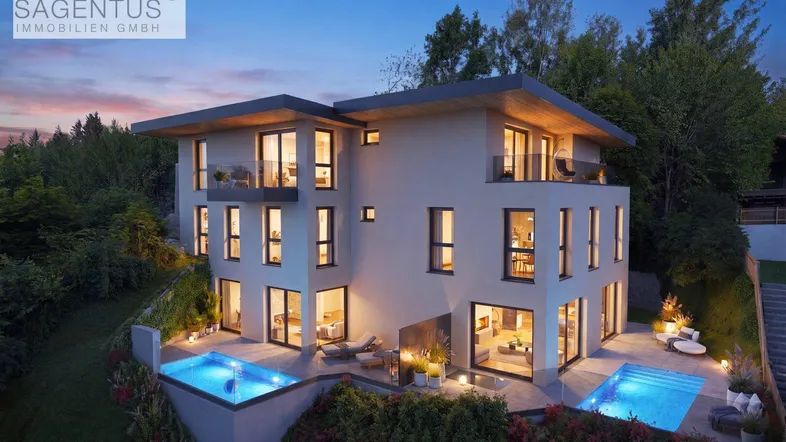 Moderne Villa bei Sonnenuntergang mit beleuchteten Pools und luxuriöser Architektur.