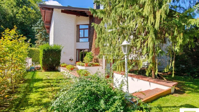 Charmantes Haus mit gepflegtem Garten und üppiger Vegetation in sonniger Lage.