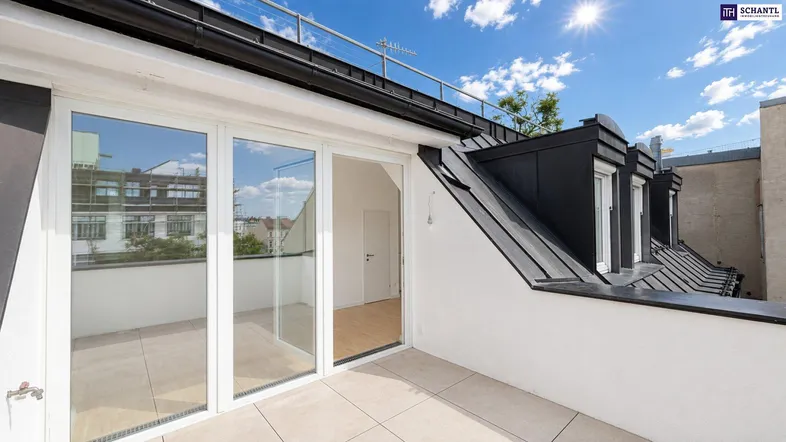 Zugang zu einer sonnigen Dachterrasse mit großen Glasfronten und Blick auf die Umgebung.