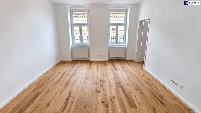 Helles Zimmer mit neuem Holzboden und zwei Fenstern, bereit zur individuellen Gestaltung.