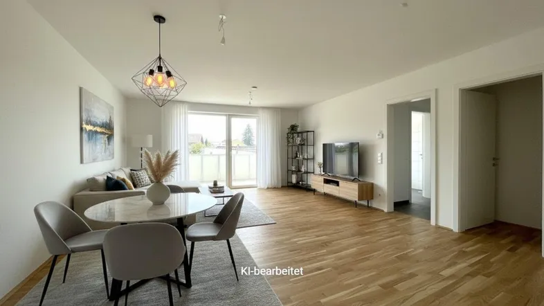 Heller, offener Wohn- und Essbereich mit modernem Mobiliar und Zugang zum Balkon.