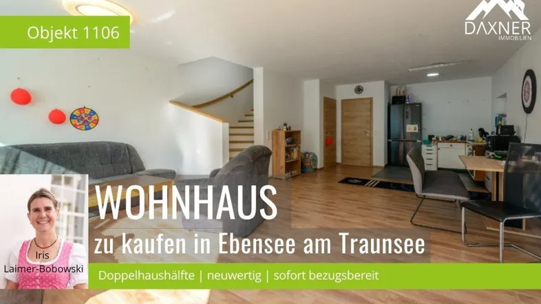 Heller offener Wohnbereich mit Holzfußboden, Treppe und angrenzender Küchenzeile.