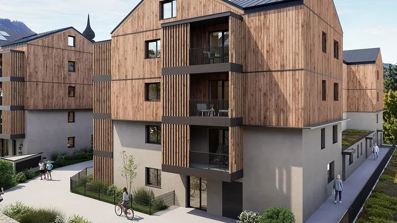 Moderne Wohnanlage mit Holzfassade und Balkonen, umgeben von Grünflächen und Wegen.