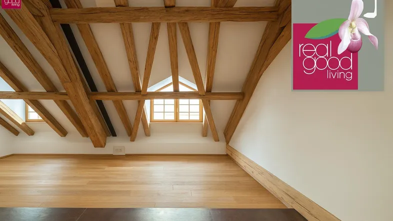 Geräumiger Dachbodenraum mit freiliegenden Holzbalken und hellem Holzfußboden.