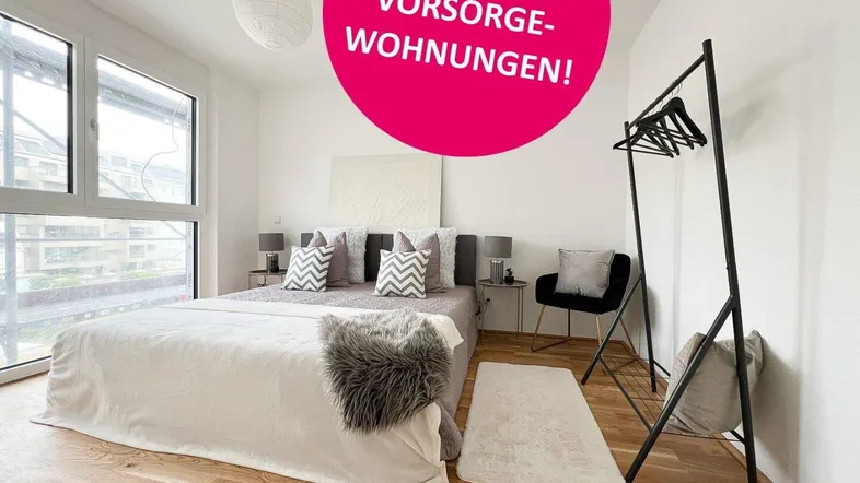 Helles Schlafzimmer mit Holzboden, großen Fenstern und moderner Einrichtung, ideal für entspannte Nächte in urbaner Umgebung.