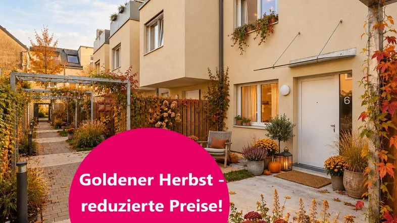 Moderne Reihenhäuser mit herbstlicher Dekoration und einladendem Eingangsbereich, umgeben von Grünflächen.