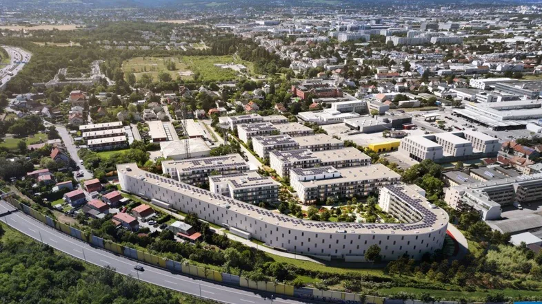 Luftaufnahme eines modernen Wohnkomplexes in einer städtischen Umgebung mit viel Grün und Infrastruktur.