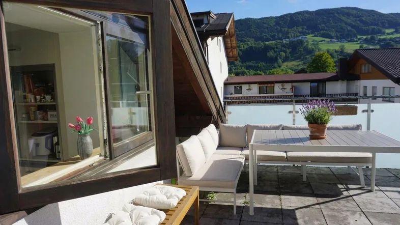 Geräumige Terrasse mit Sitzgelegenheiten und Bergblick, ideal für entspannte Stunden im Freien.