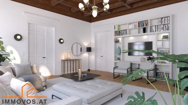 Helles Wohnzimmer mit Holzkassettendecke, Bücherregal und modernen Möbeln in einem luxuriösen Ambiente.