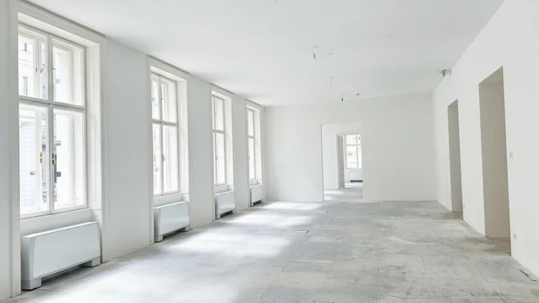 Großer, heller Büroraum mit hohen Fenstern und hellem Fliesenboden, bereit für die individuelle Gestaltung.