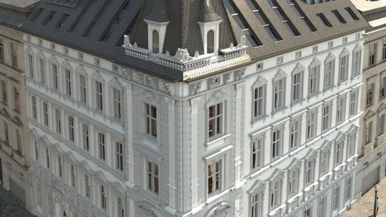Luftaufnahme eines eleganten Eckgebäudes mit klassischer Architektur und modernen Dachgauben.