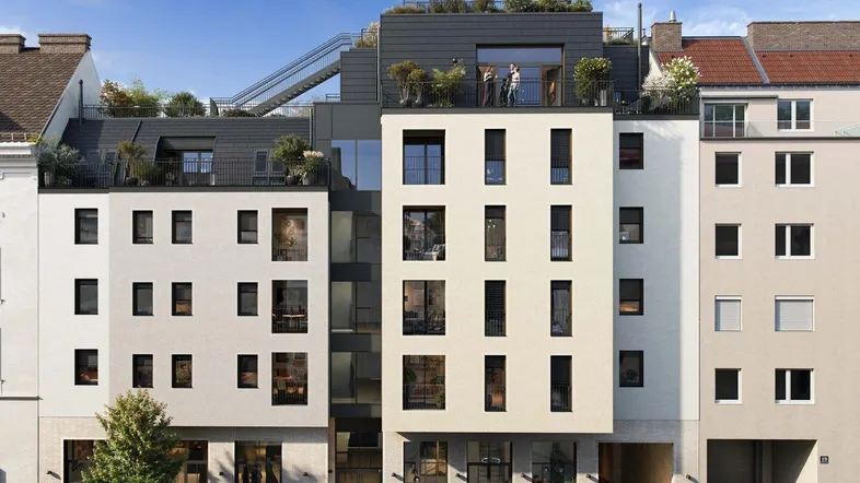 Moderne Fassade eines Neubaus mit Geschäften im Erdgeschoss und Dachterrassen.