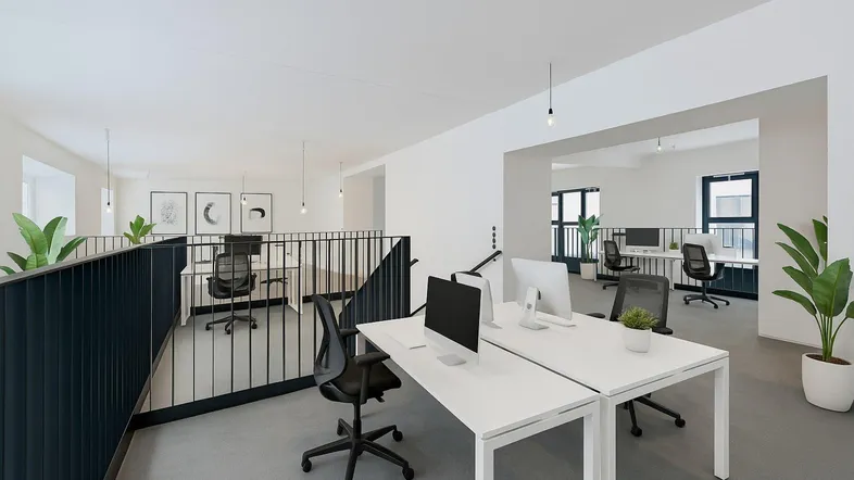 Modernes, offenes Büro mit mehreren Arbeitsplätzen auf zwei Ebenen, hohen Decken und viel Tageslicht.