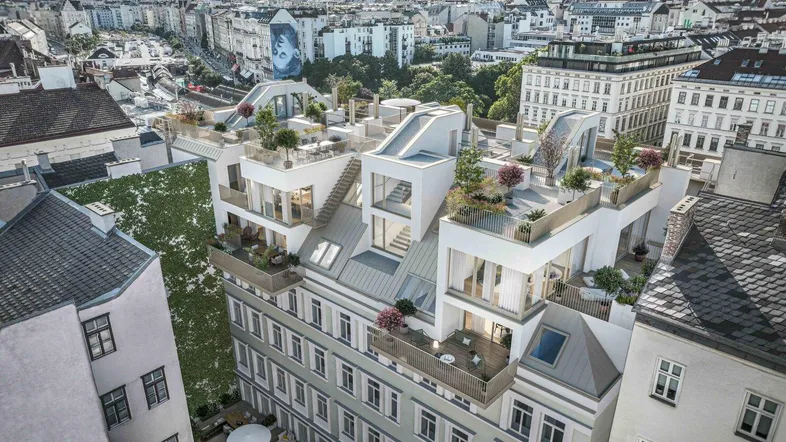 Luftaufnahme eines modernen Gebäudes mit Dachterrassen und Stadtblick.