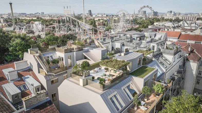 Luftaufnahme eines modernen Gebäudes mit Dachterrassen und Blick auf die Wiener Skyline und den Prater.