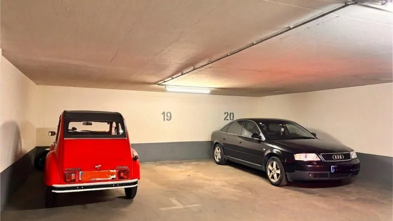 Tiefgarage mit zwei Stellplätzen und Betonwänden, gut beleuchtet.