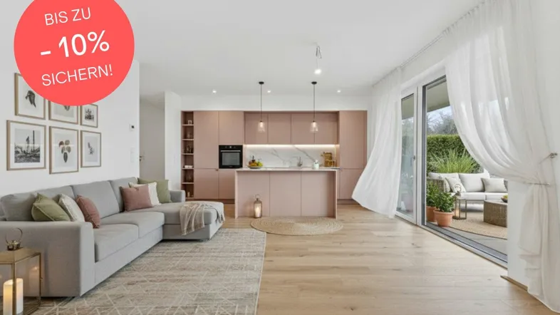 Moderner offener Wohn-Essbereich mit rosafarbener Küche, Holzboden und Zugang zur Terrasse.
