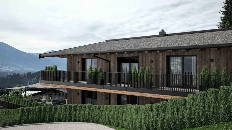 Moderne Chalet-Architektur mit Holzfassade, Balkonen und weitem Blick auf die umliegende Berglandschaft.