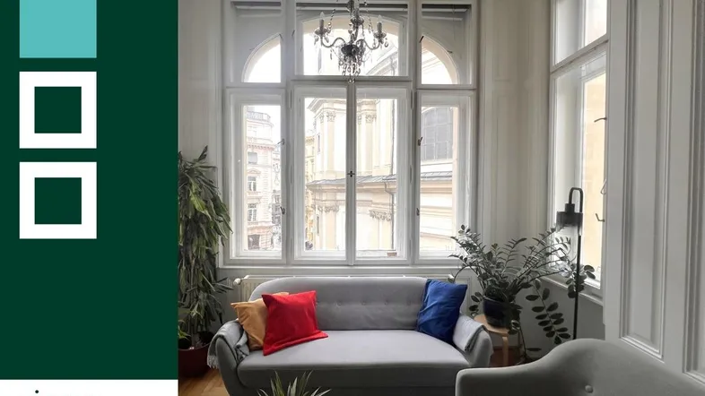 Gemütliches Wohnzimmer mit großen Fenstern, bequemen Sofas und Pflanzen, hell und einladend.