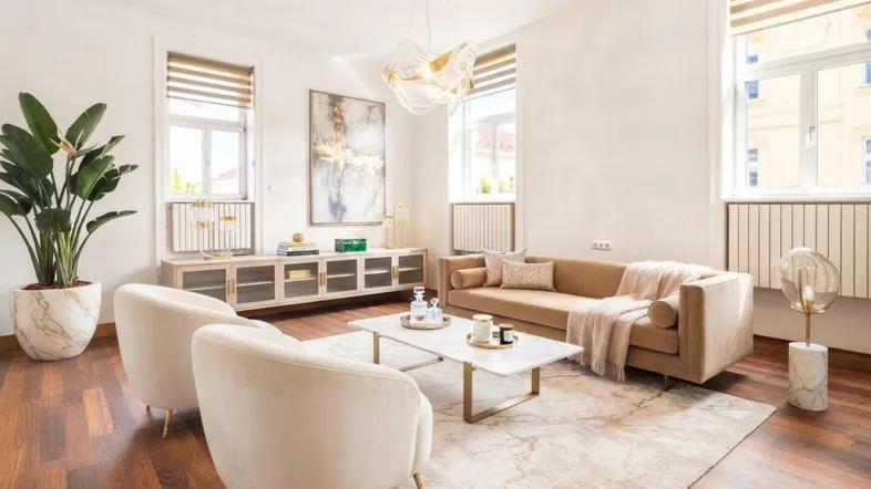 Helles Wohnzimmer mit modernem Mobiliar, Holzboden und großen Fenstern, die viel Tageslicht hereinlassen.