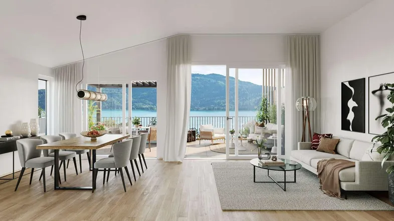 Heller Wohn- und Essbereich mit modernem Design, Holzboden und Zugang zu einem Balkon mit Seeblick.