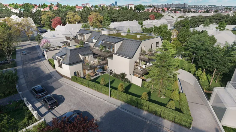 Moderne Wohnanlage mit mehreren Balkonen und begrünten Dächern in einer grünen Umgebung.