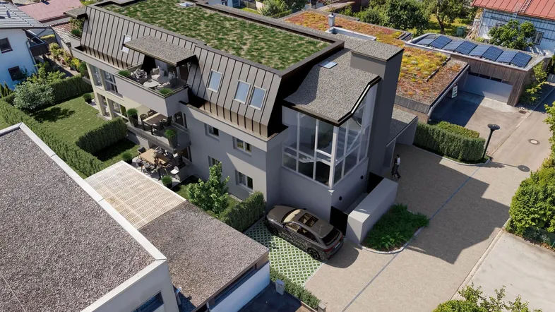 Moderne Wohnanlage mit begrüntem Dach, großzügigen Balkonen und Glasfassade in grüner Umgebung.