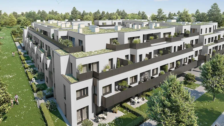 Moderne Wohnanlage mit Flachdächern, begrünten Terrassen und Balkonen in einer grünen Umgebung.