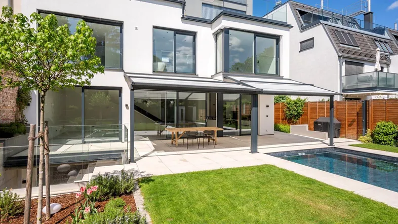 Moderne Villa mit großzügigem Garten, Terrasse und privatem Pool für entspanntes Wohnen im Freien.