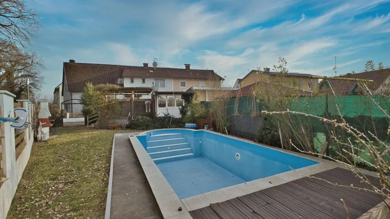 Großer Garten mit Pool und Rasenfläche, ideal für Entspannung und Freizeit im Freien.