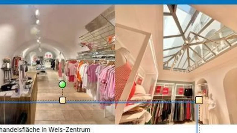 Innenansicht eines Einzelhandelsgeschäfts mit gewölbten Decken, Holzfußboden und einem großen Oberlicht.
