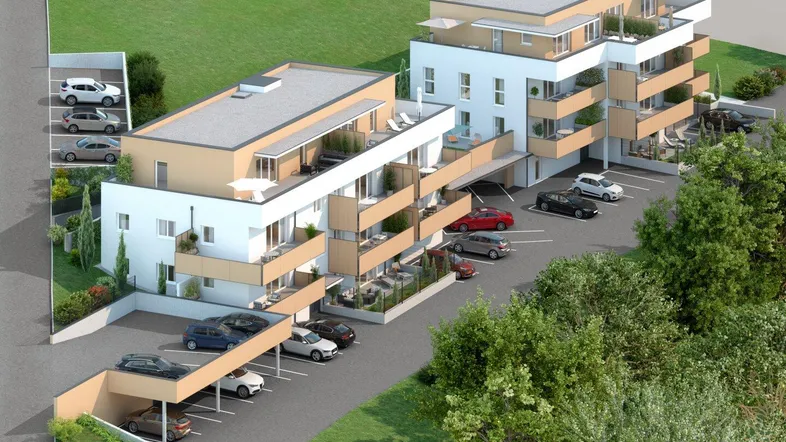 Moderne Wohnanlage mit mehreren Gebäuden, Balkonen und Carports in grüner Umgebung.