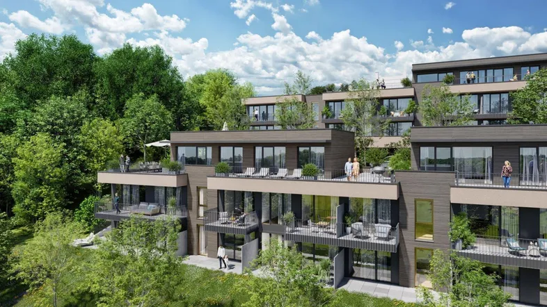 Moderne Terrassenwohnungen in Hanglage mit begrünten Dächern und großzügigen Balkonen und Terrassen.