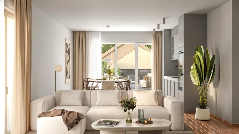 Modernes, offenes Wohnzimmer mit Essbereich und integrierter Küchenzeile, hell und freundlich gestaltet.
