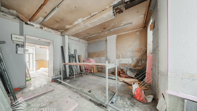 Innenraum in Renovierungsphase mit sichtbaren Baumaterialien und unfertigen Wänden und Decken.
